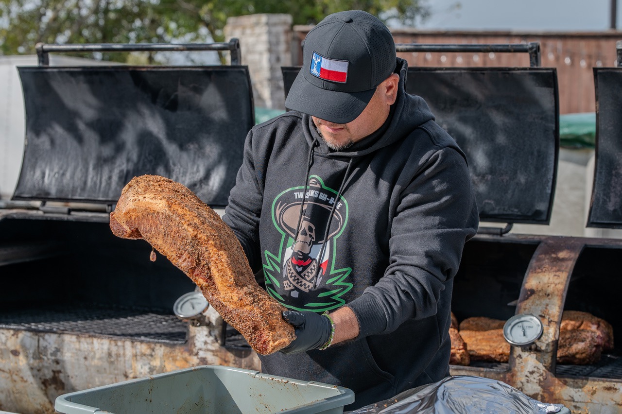 Man adding seasoning to the beef